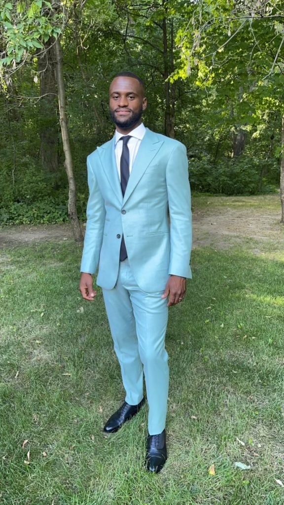 Festive light blue suit with thin black tie, an excellent option for a dress to impress wedding dress code
