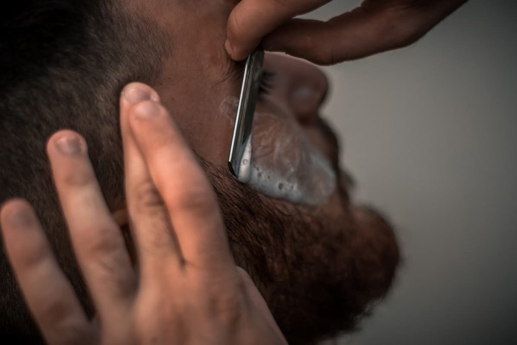 Man being shave with dedicated beard basic products