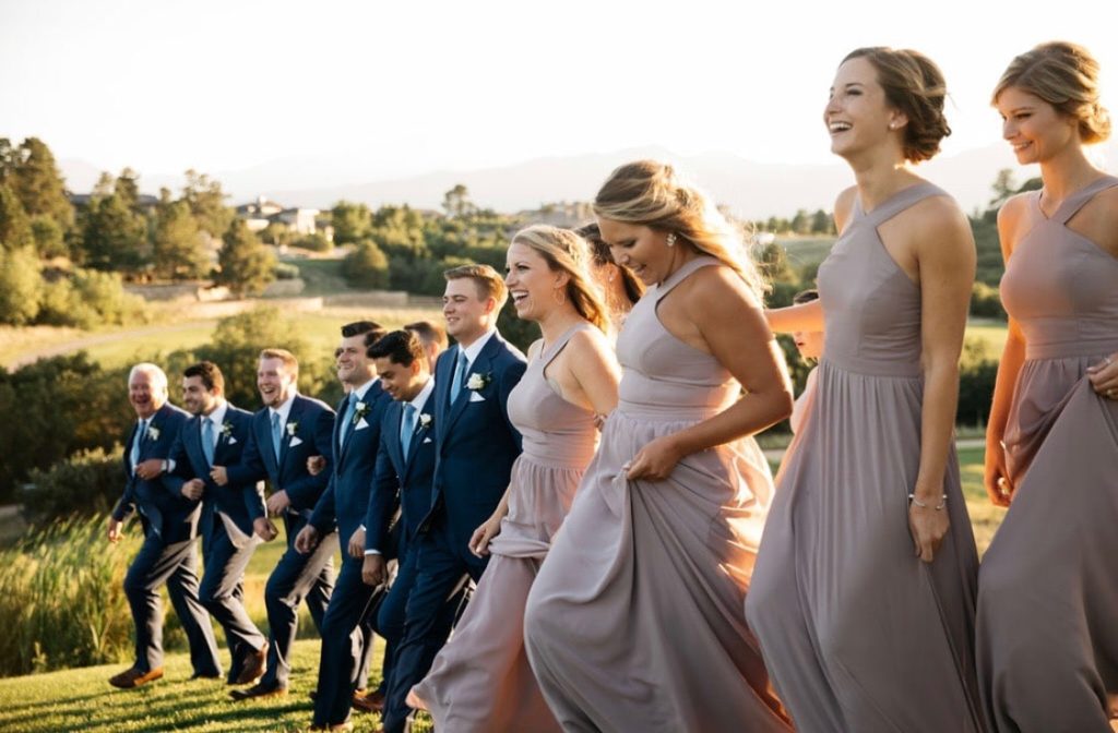 Wedding party with matching themed bridesmaid and groomsman attire