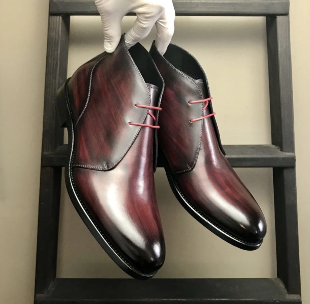 A pair of burgundy patina chukka shoes with goodyear welt.