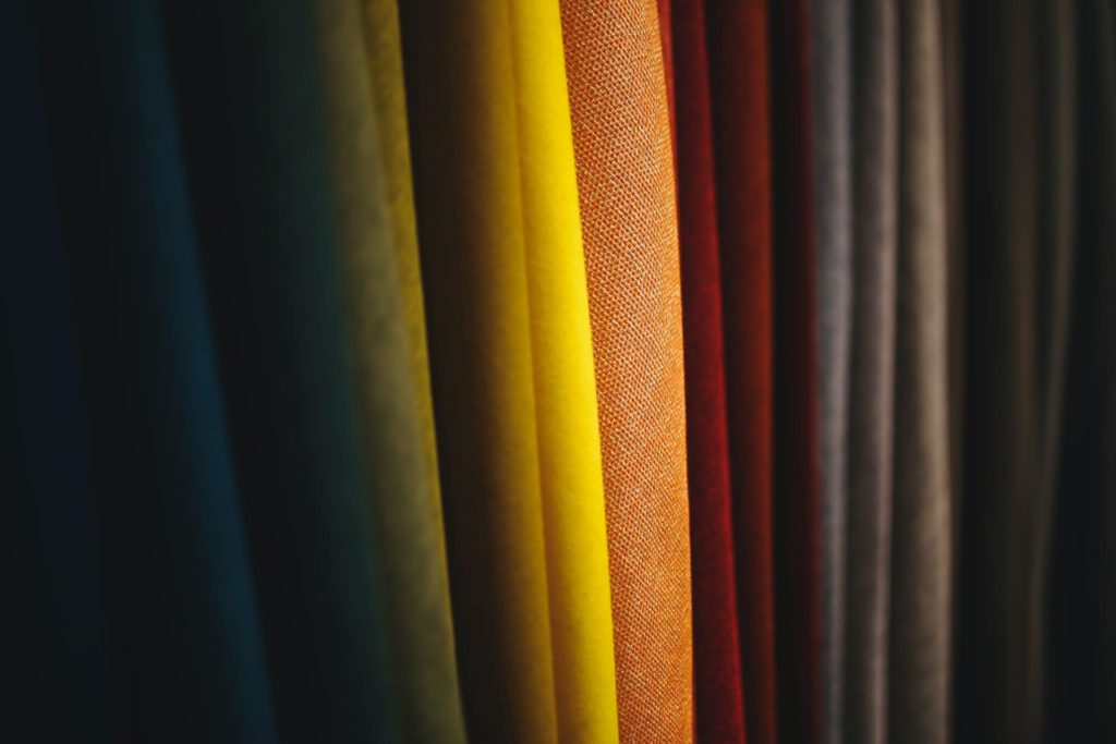 Layered fabrics in yellow, red, brown, and grey
