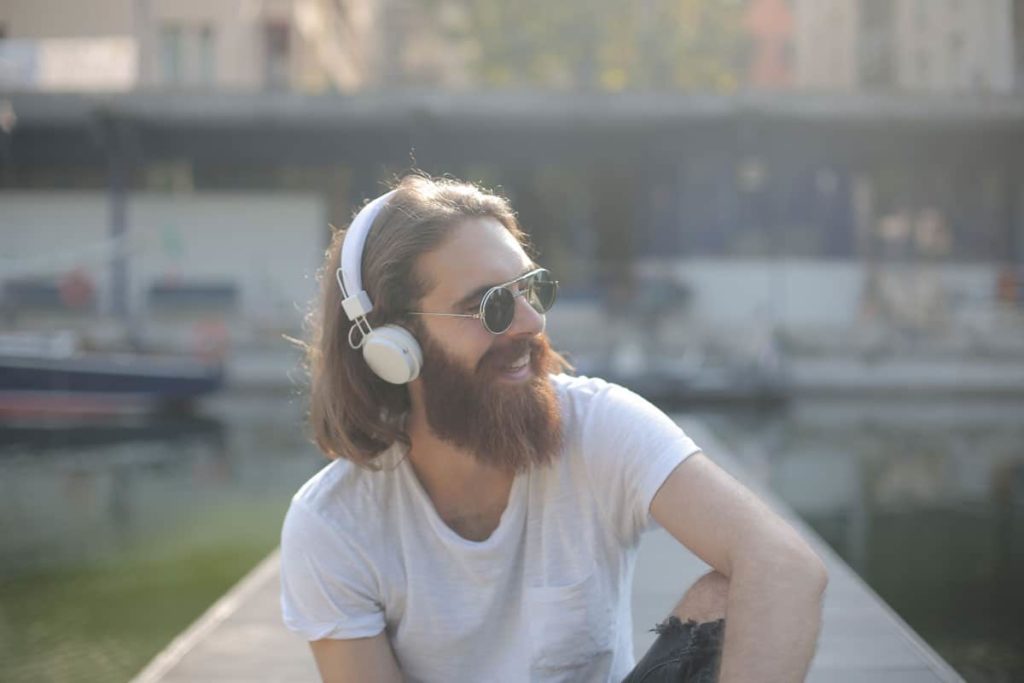 Man in white crew neck with long but well kept beard