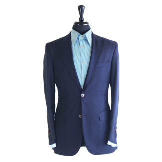 A navy blue suit jacket on a body form with a sky blue pin striped shirt on a white background