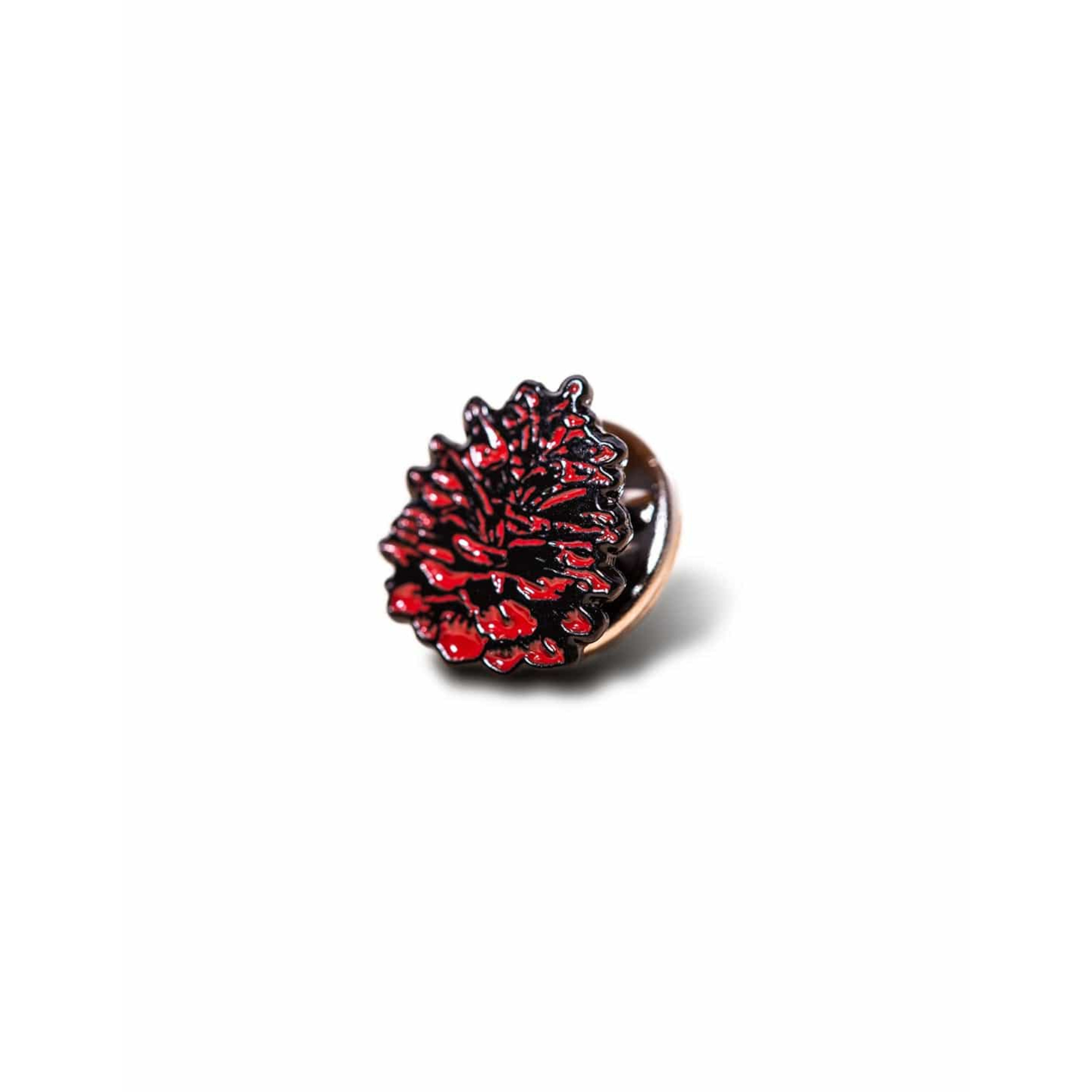 Red acorn lapel pin on a white background