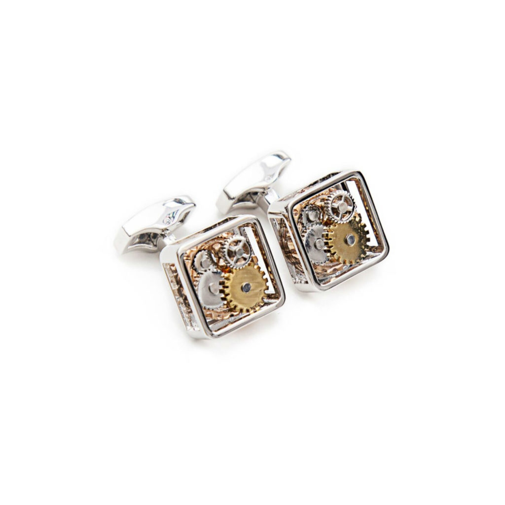 Square silver cufflinks with visible gears on a white background