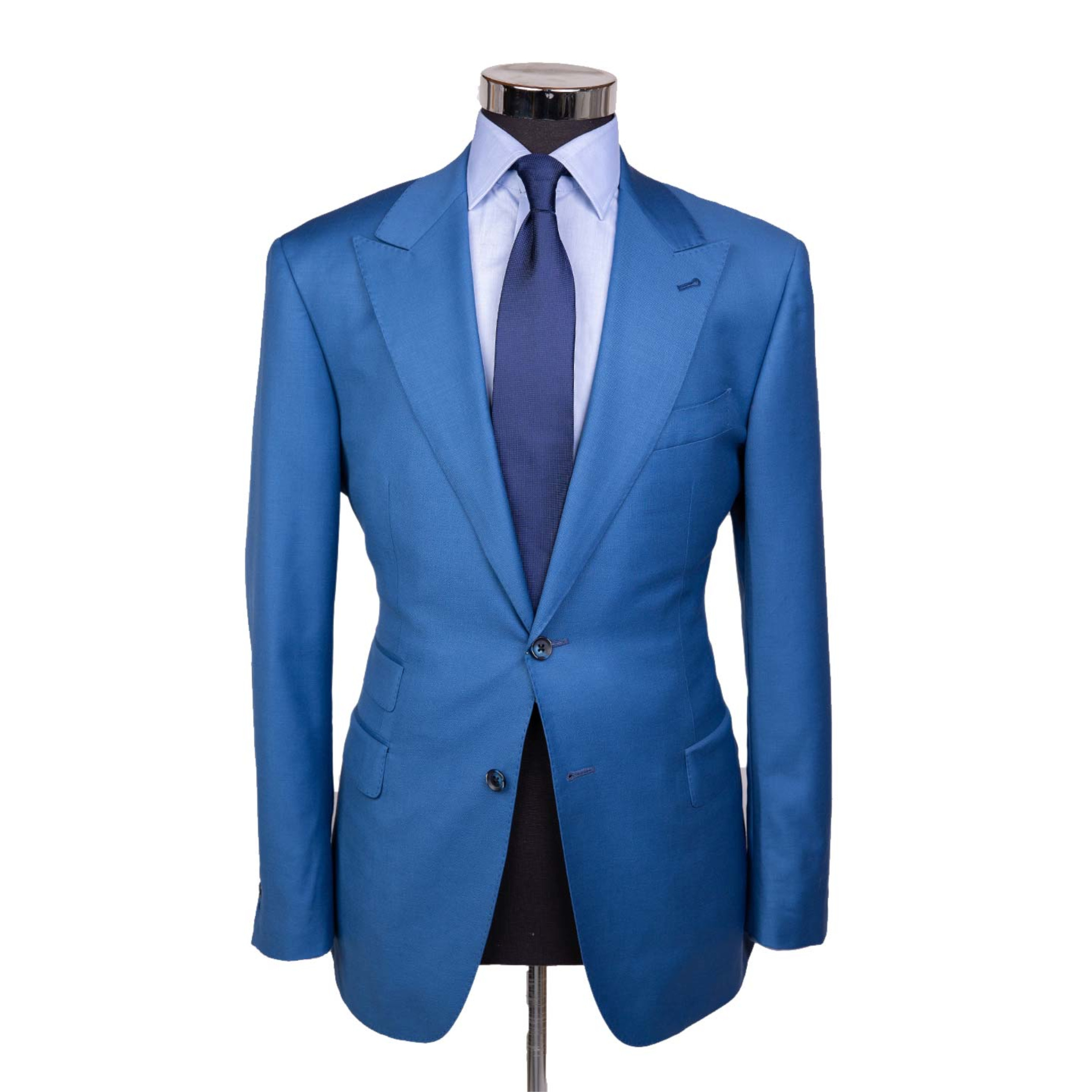 A bright sky blue suit jacket on a body form with a cobalt blue tie and light blue shirt on a white background