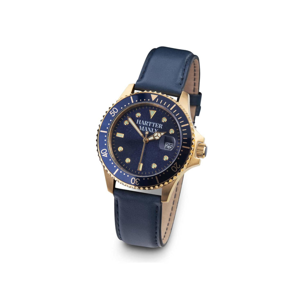A cobalt blue and gold watch with a cobalt blue leather band on a white background