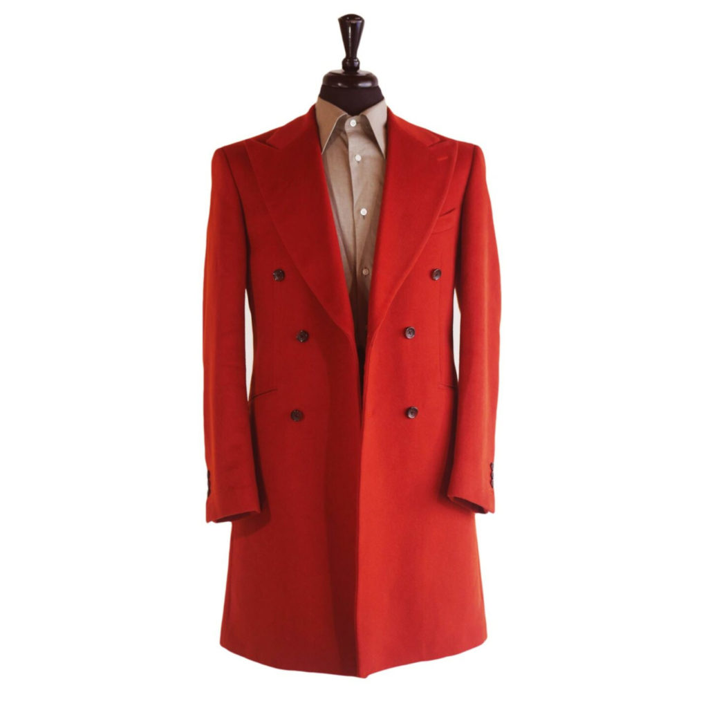 Overcoats -Vogue Red. An orange-red knee length overcoat on a body form with a tan shirt on a white background