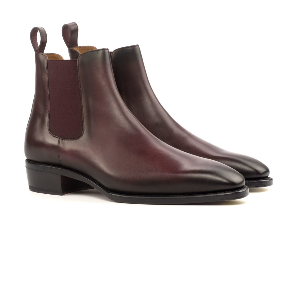The Slingshot: Burgundy Painted. Burgundy painted calf leather Chelsea syle ankle boot with rear finger loops on a white background