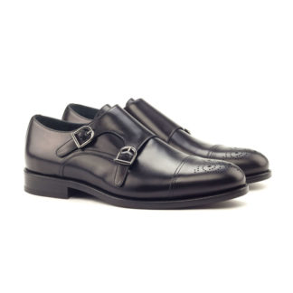 The Kirigami: Onyx Patina Brogue double monk shoes against a white background.