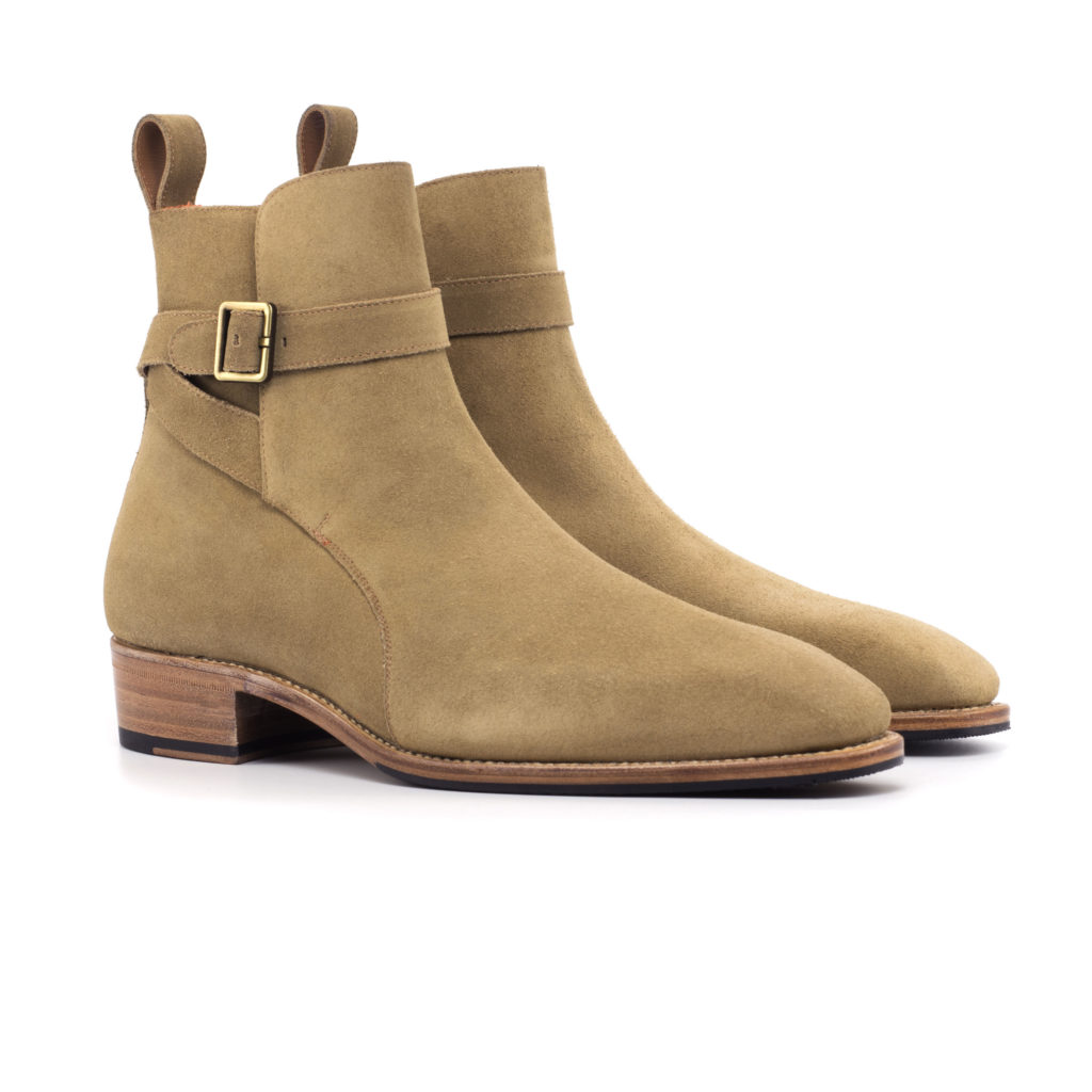 The Stallion: Camel. Camel colored luxury suede riding style ankle boots with strap and buckle on a white background