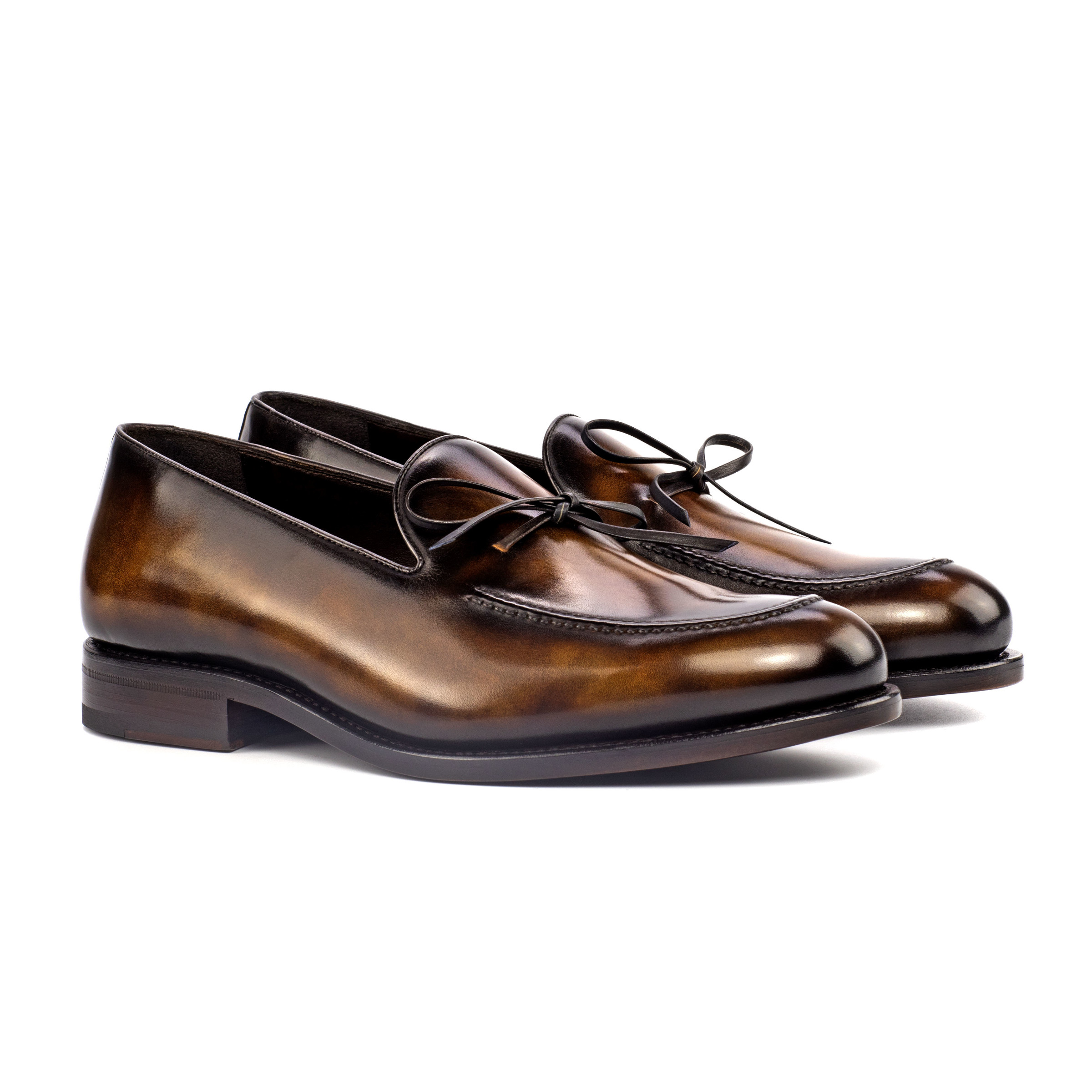 The Richmond: Tobacco Patina. Tobacco colored patina loafers against white background.