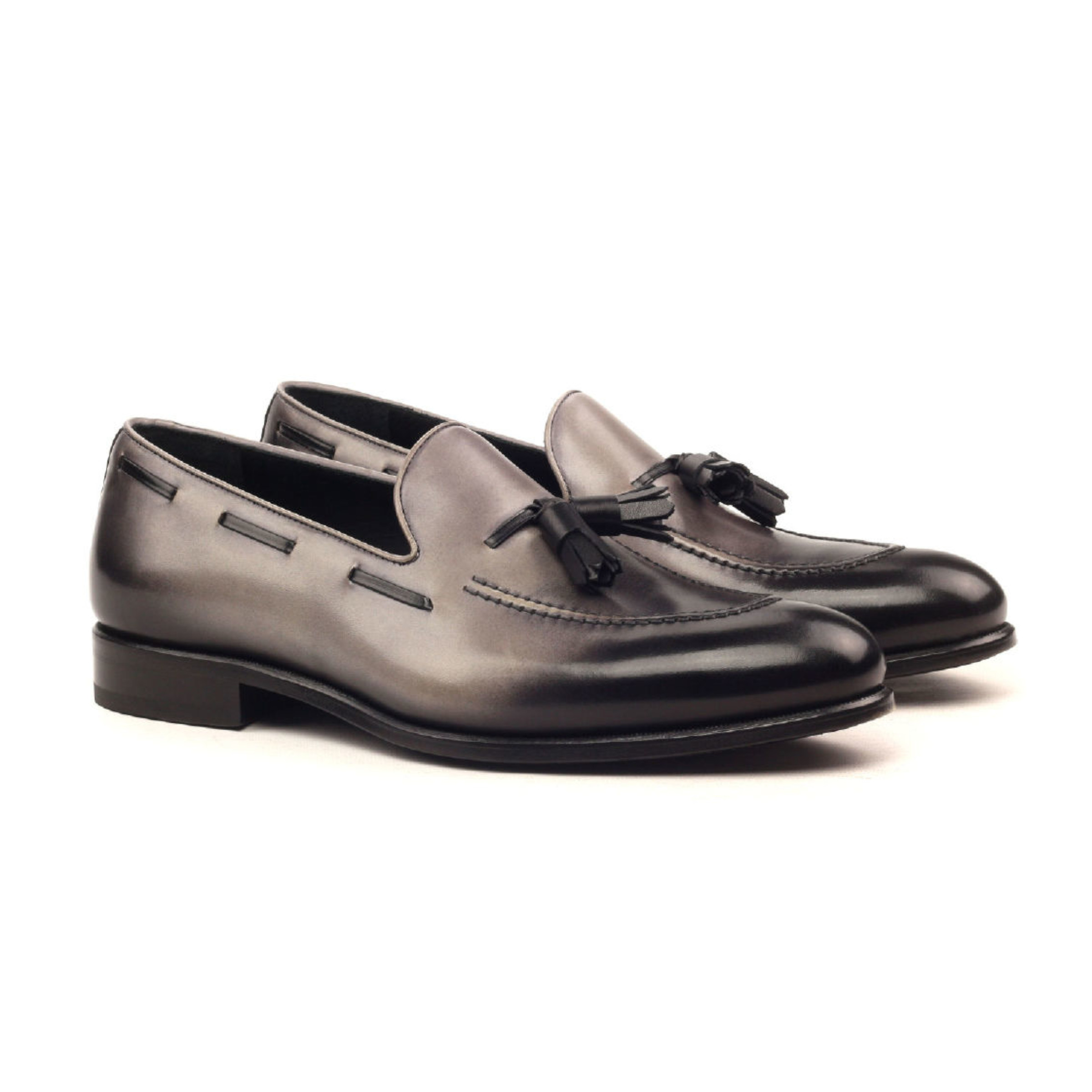 The Richmond: Bronze Calf. Loafers with grey and black painted calf leather and tassels, against a white background.