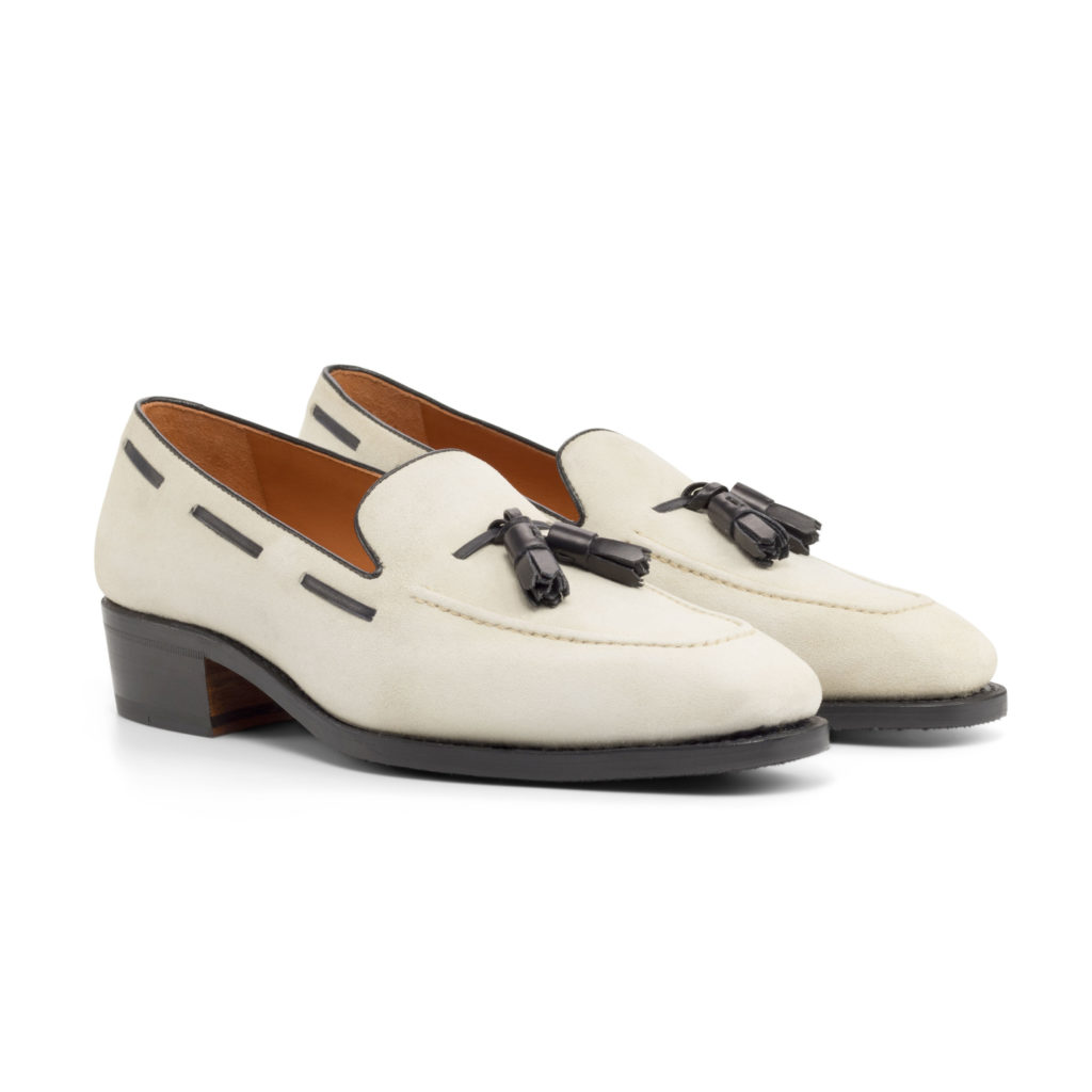 The Richmond: Tasseled Ivory. Ivory Kid Suede loafers with black tassels against white background.
