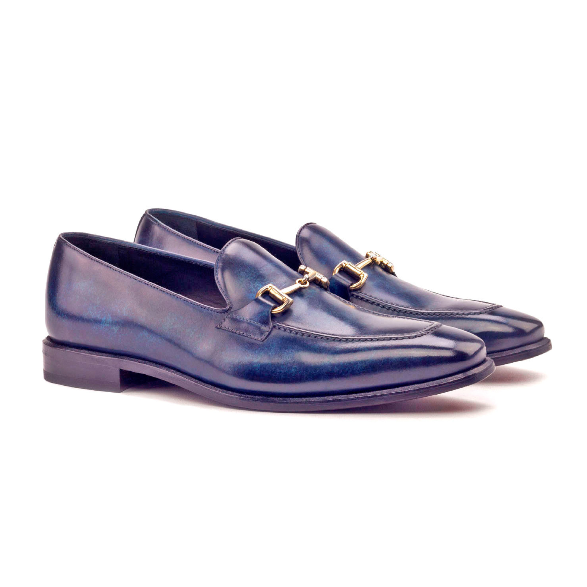 The Richmond: Peacock Patina Bit. Denim patina loafers with metal buckle against white background.