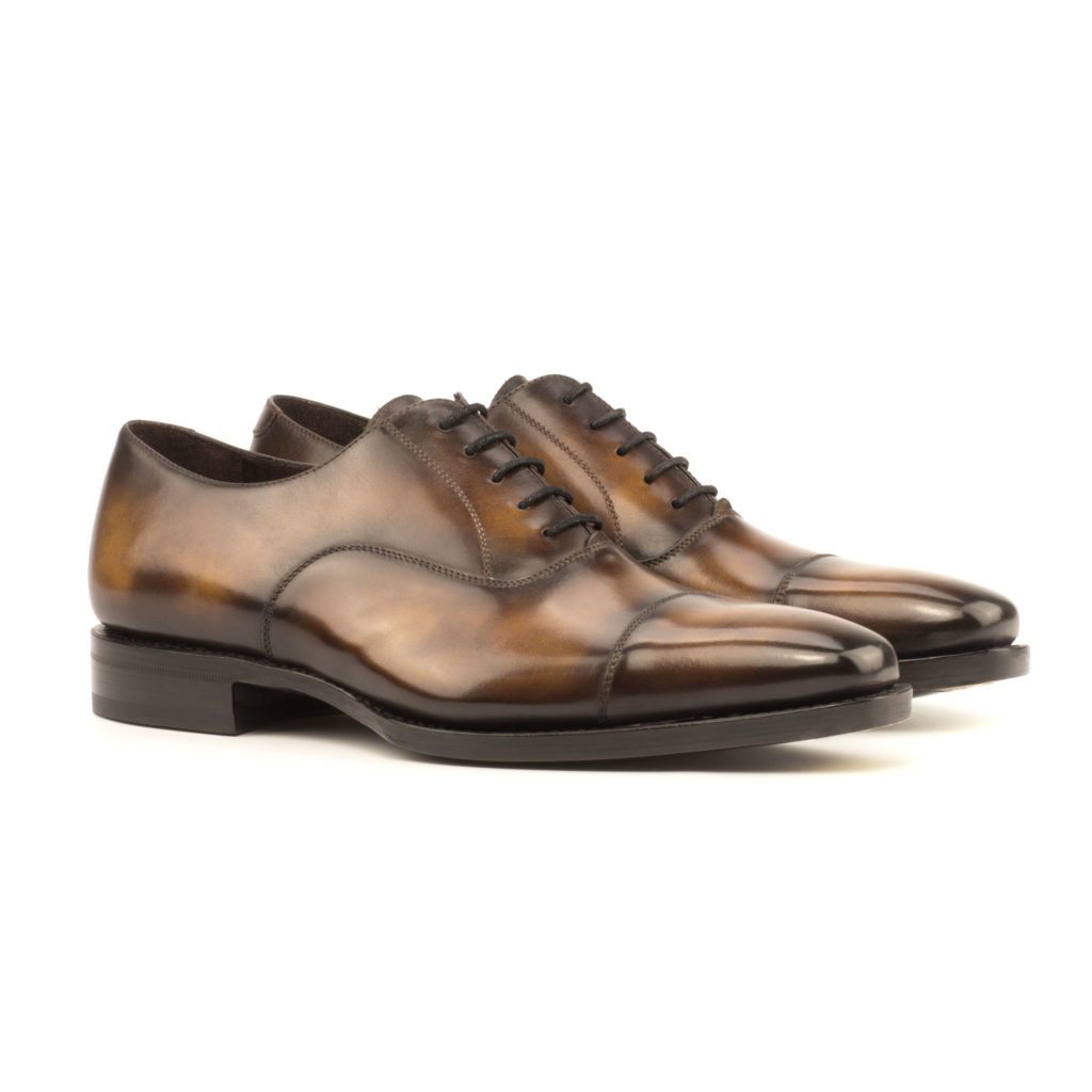 The Durham: Tobacco. Tobacco colored museum patina leather oxfords against white background.