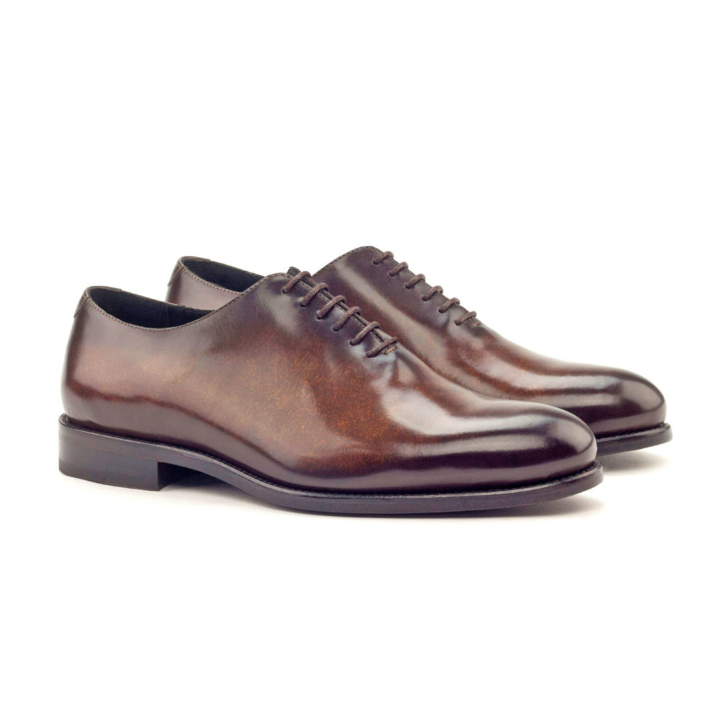 The Totem: Brown Patina Zurigo. Brown colored whole cut oxfords in marble patina against white background