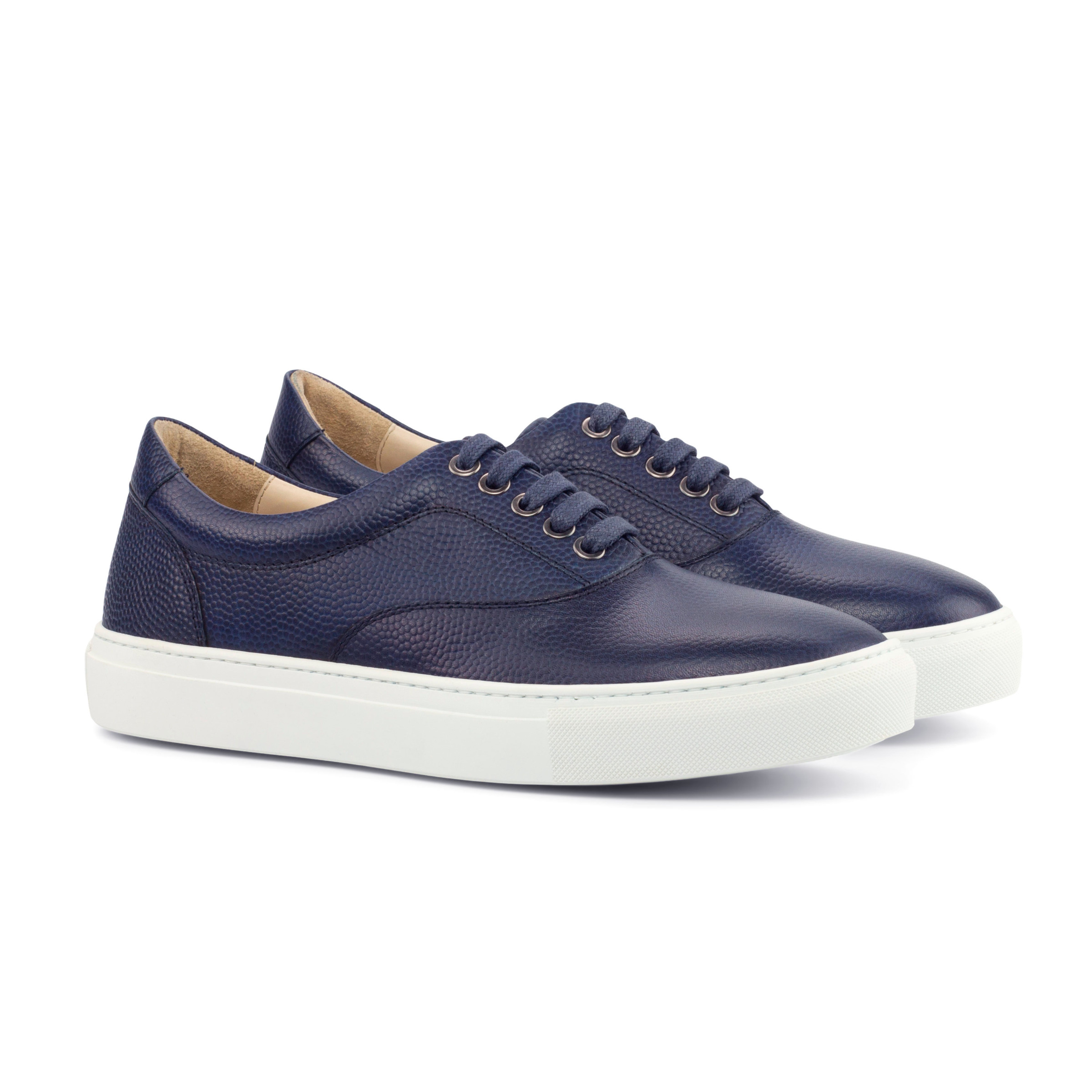 The Mariner: Navy Pebble. Navy Pebble Grain lace up style sneakers with white soles on white background