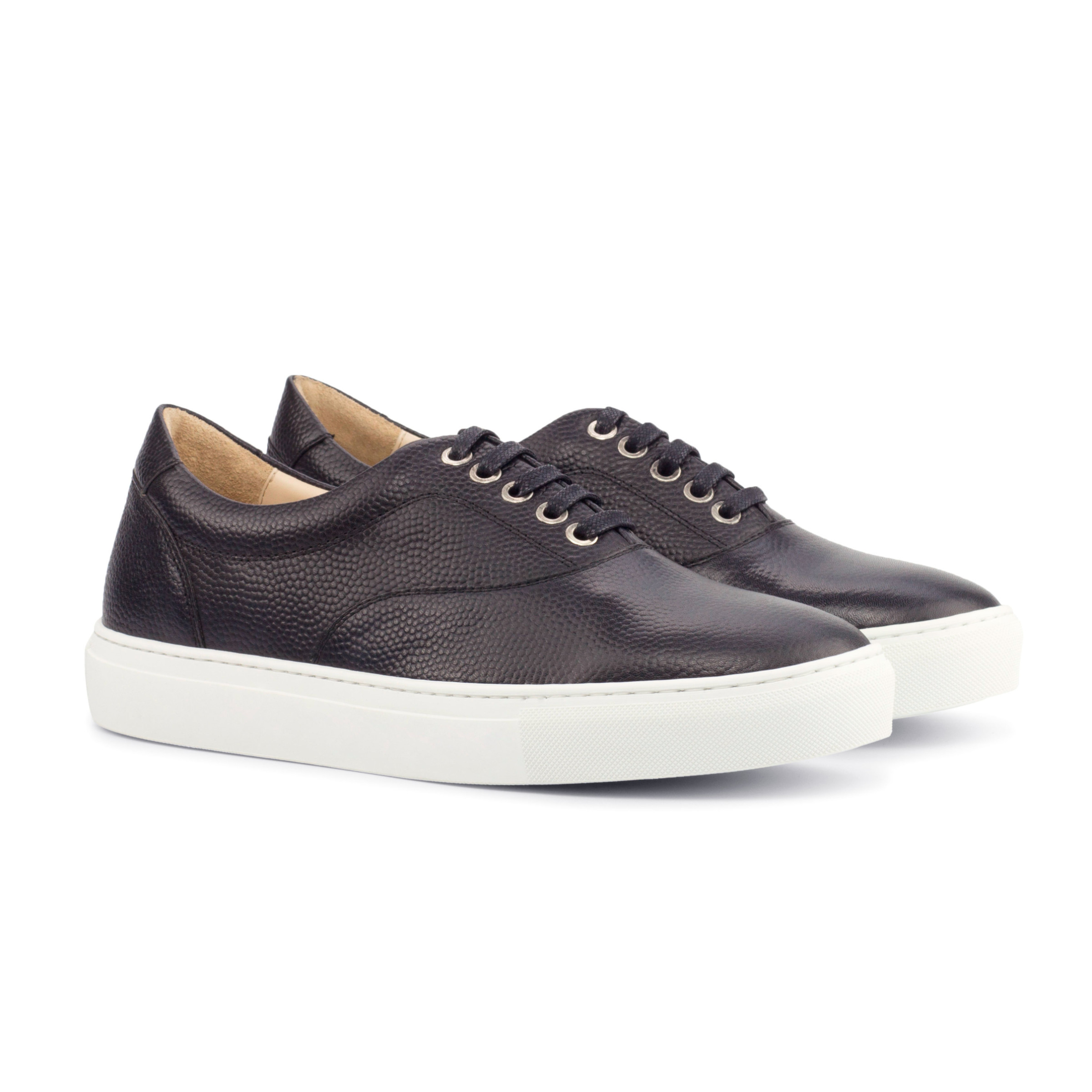 The Mariner: Oil Slick Pebble. Black Pebble Grain lace up sneaker style shoes with white soles on a white background