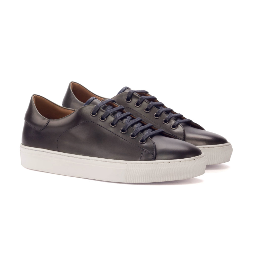 The Plimsoll: Chocolate. Grey painted calf and navy painted calf lace up trainer style shoes with white soles on a white background