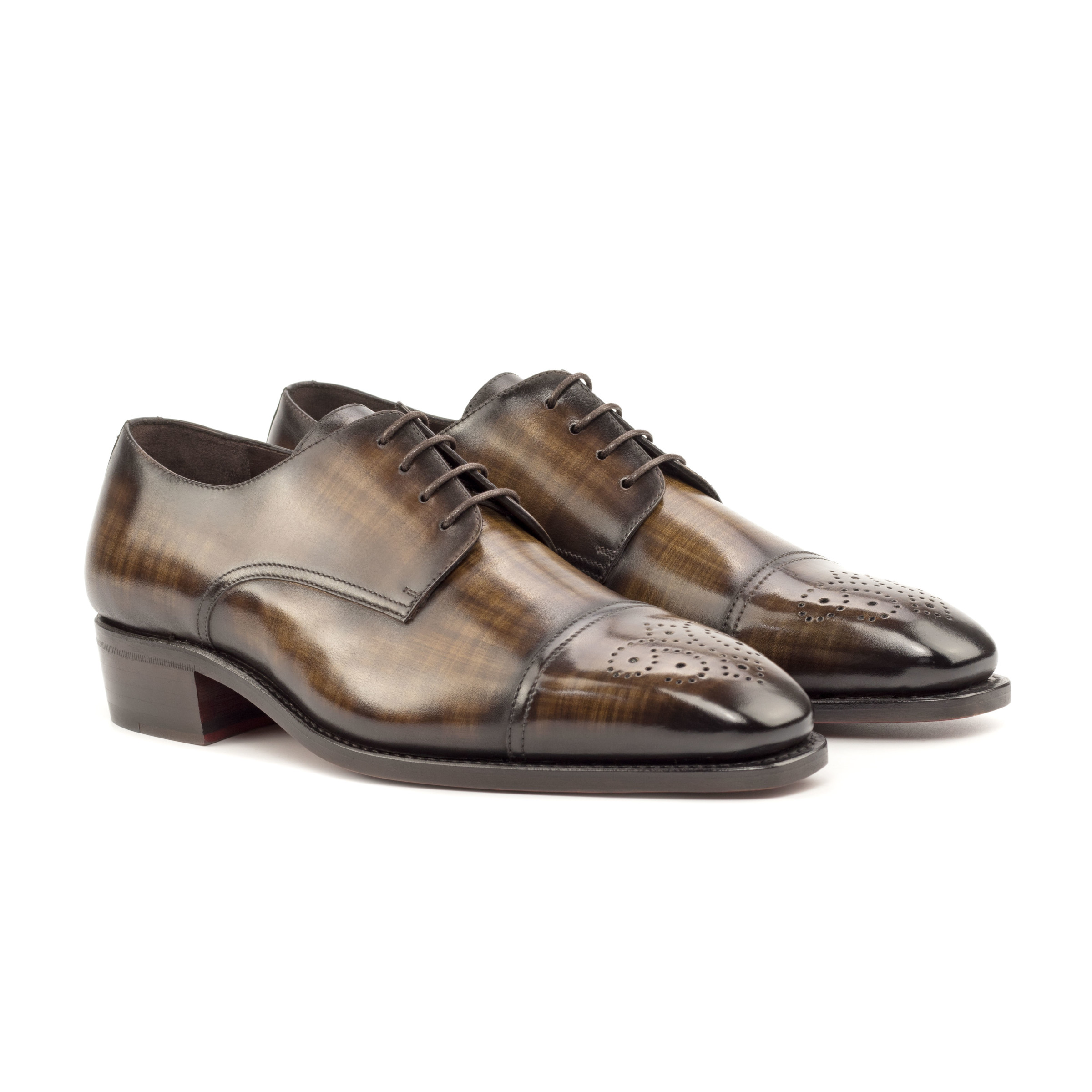 The Latus: Brown Patina. Front side view of brown patina leather men's style dress does with decorative toe cap and laces on a white background