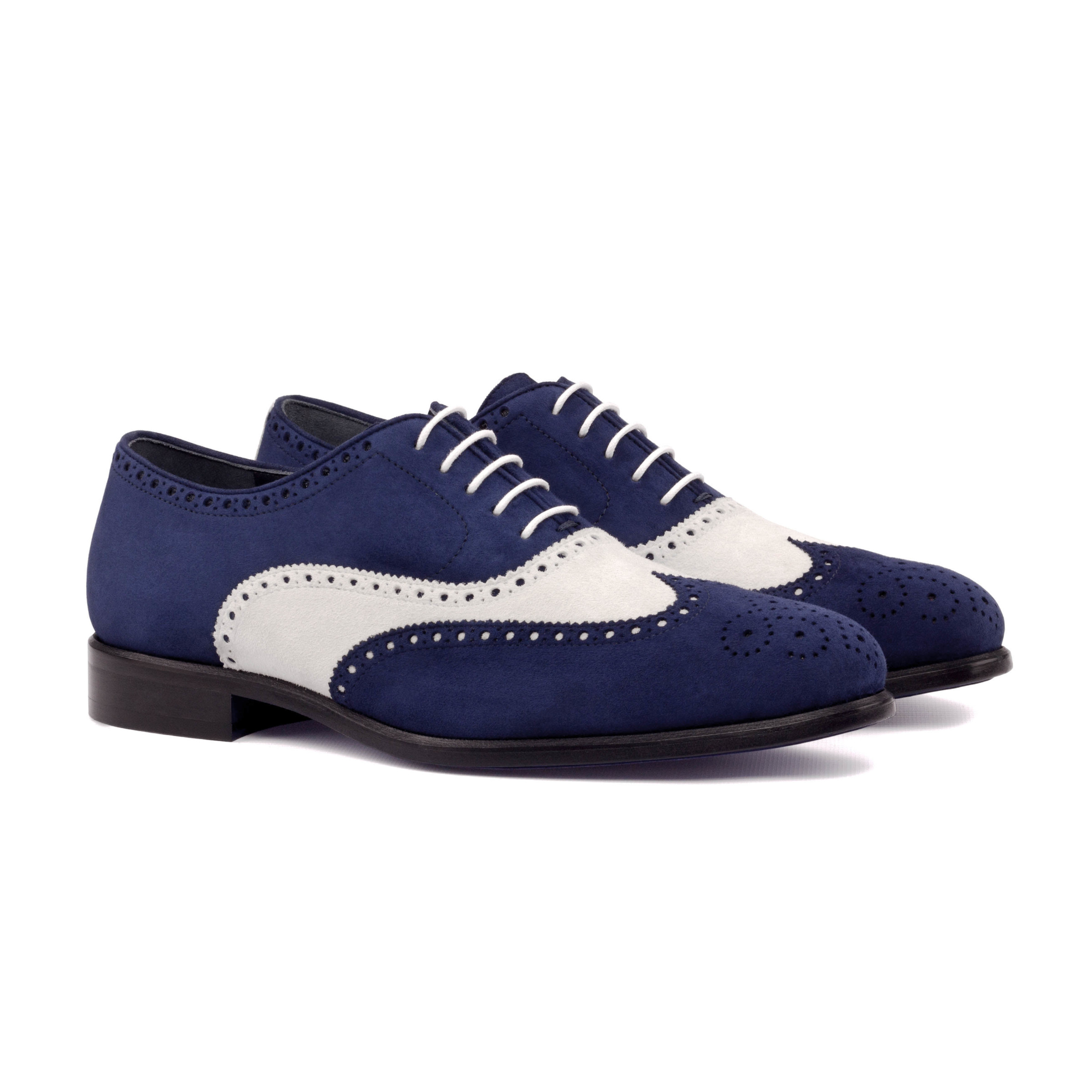 The Agent: Navy/White Suede. Front side view of navy kid suede, white kid suede men's style lace up dress shoes with decorative toe cap on white background