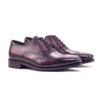 The Agent: Burgundy Patina. Front facing view of burgundy patina leather men's style lace up dress shoes on a white background