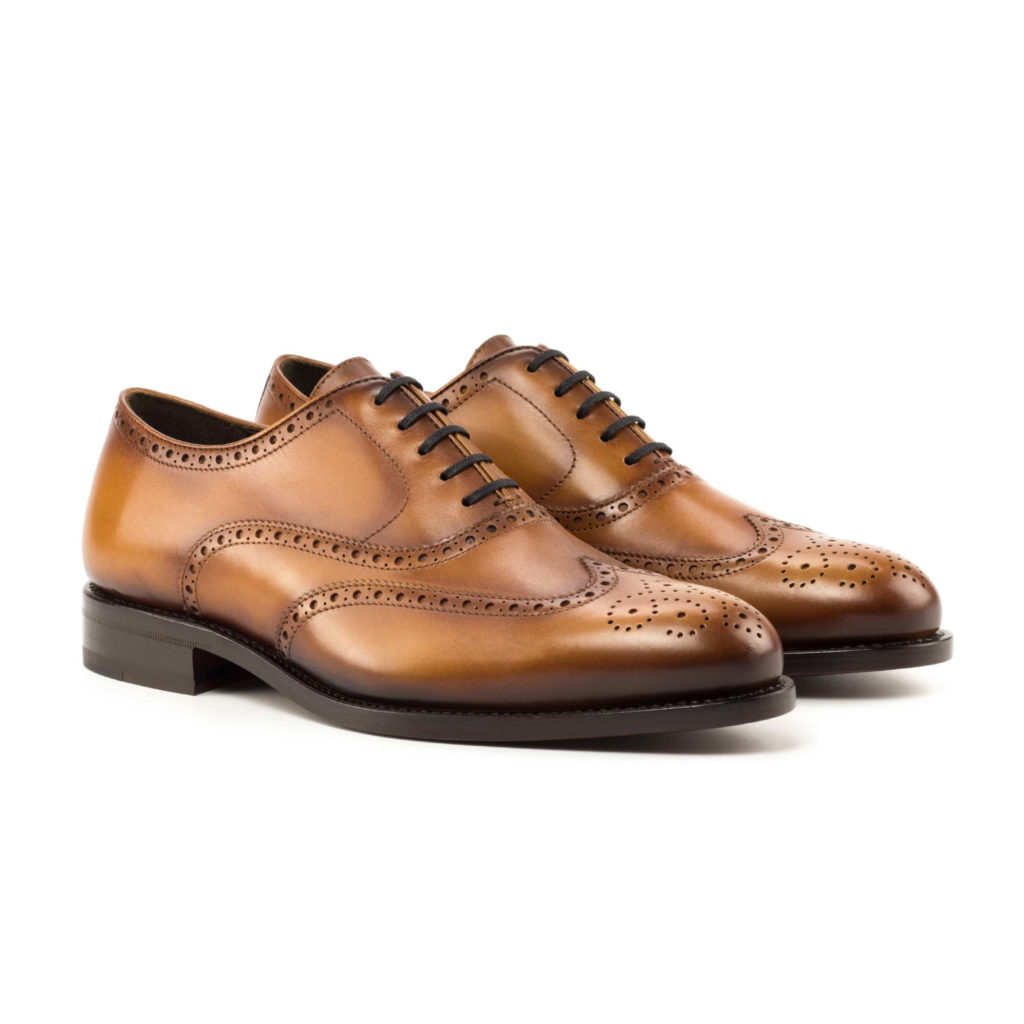 The Agent: Cognac Box Calf. Front facing view of cognac box calf leather men's style lace up dress Shoes with decorative toe cap on white background