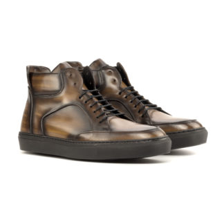 Front side view of high top: chocolate patina. Featuring brown patina leather high top sneaker style shoes with black soles on a white background