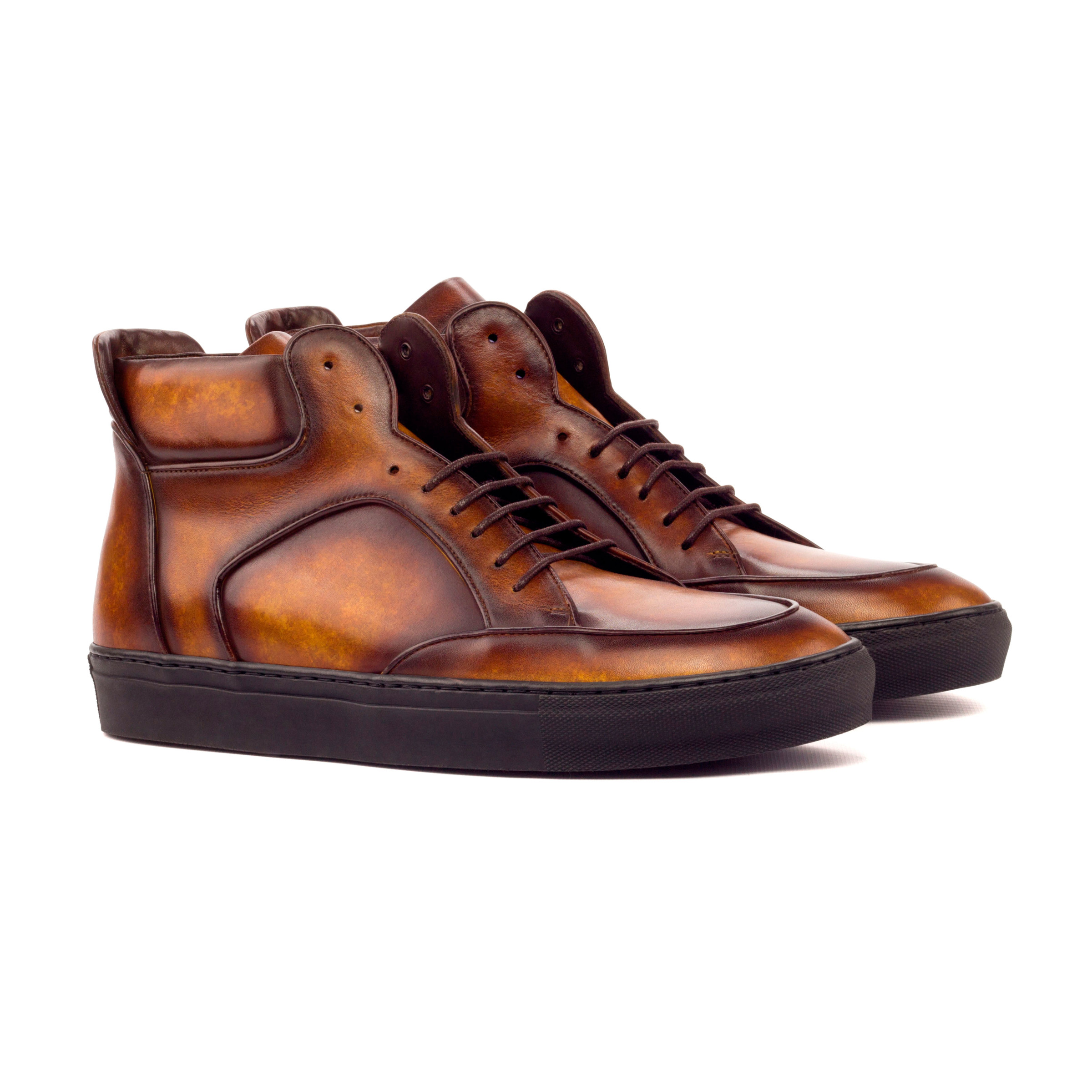 Front side view of the high top: cognac patina leather style sneakers with black soles on a white background