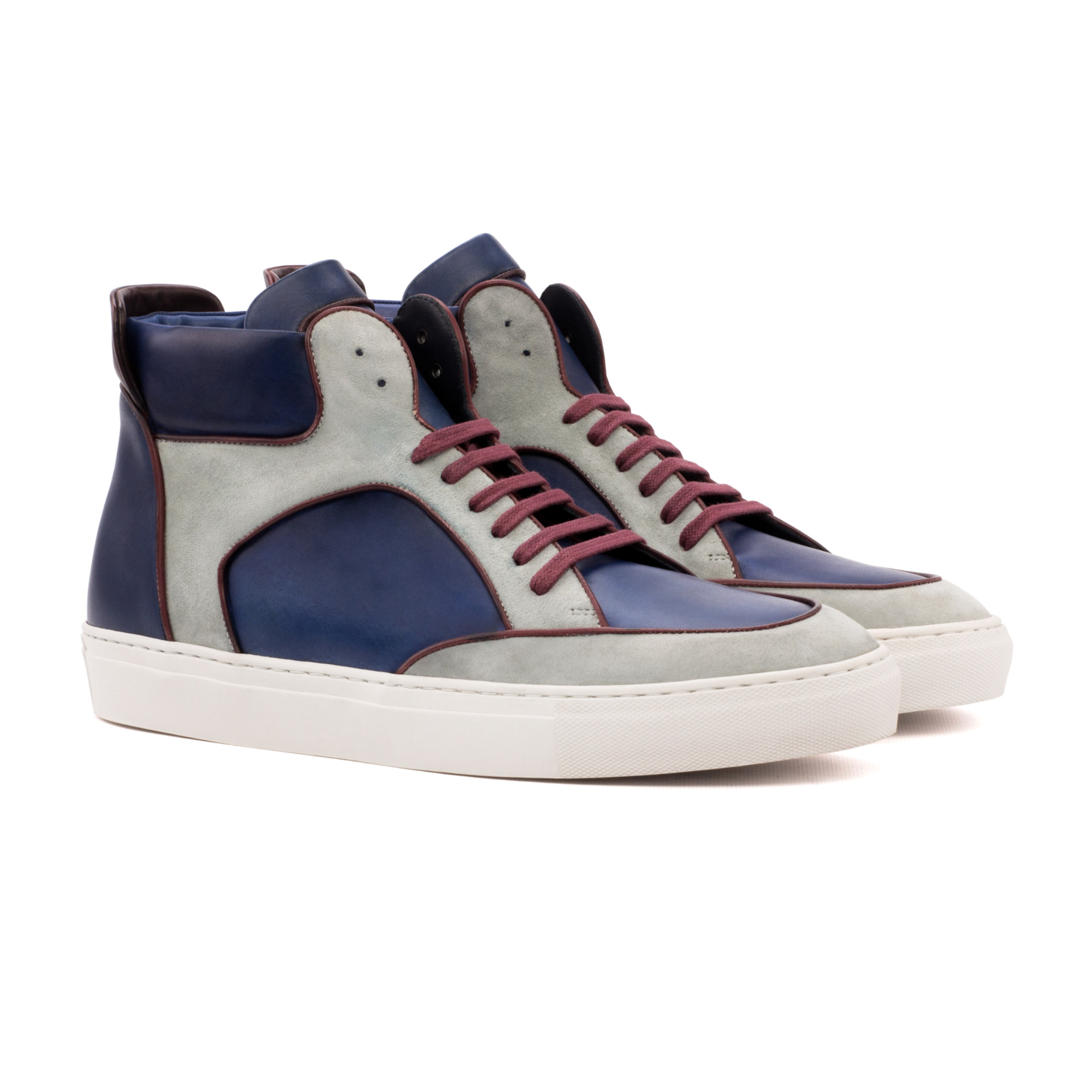 The High Top: Hero Patina. Front side view of burgundy painted calf, navy painted calf, light grey kid suede high top style sneakers with white soles on a white background