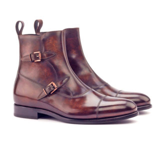 The Octavian: Tobacco Patina. Front side view of brown patina leather ankle boots with 2 buckles on a white background