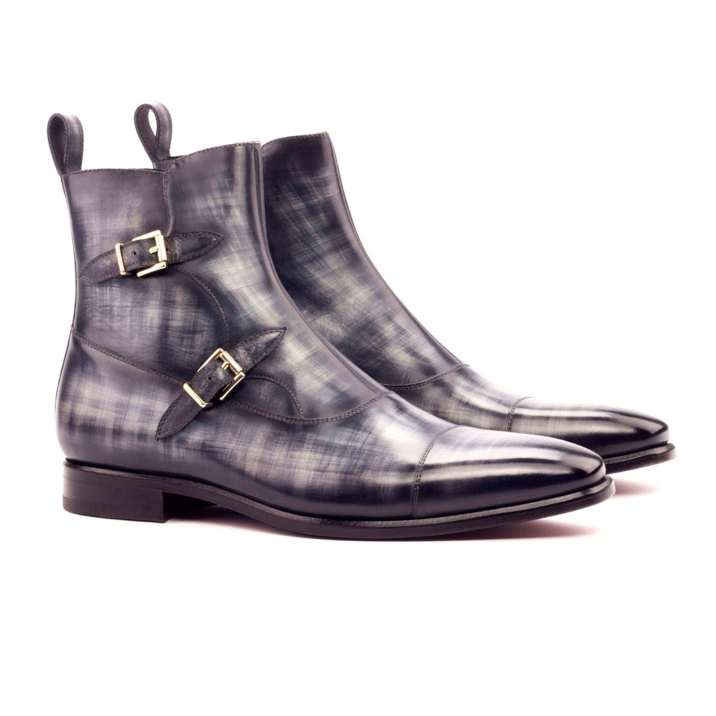 The Octavian: Charcoal Patina. Front side view of grey patina leather ankle boots with 2 buckles on white background