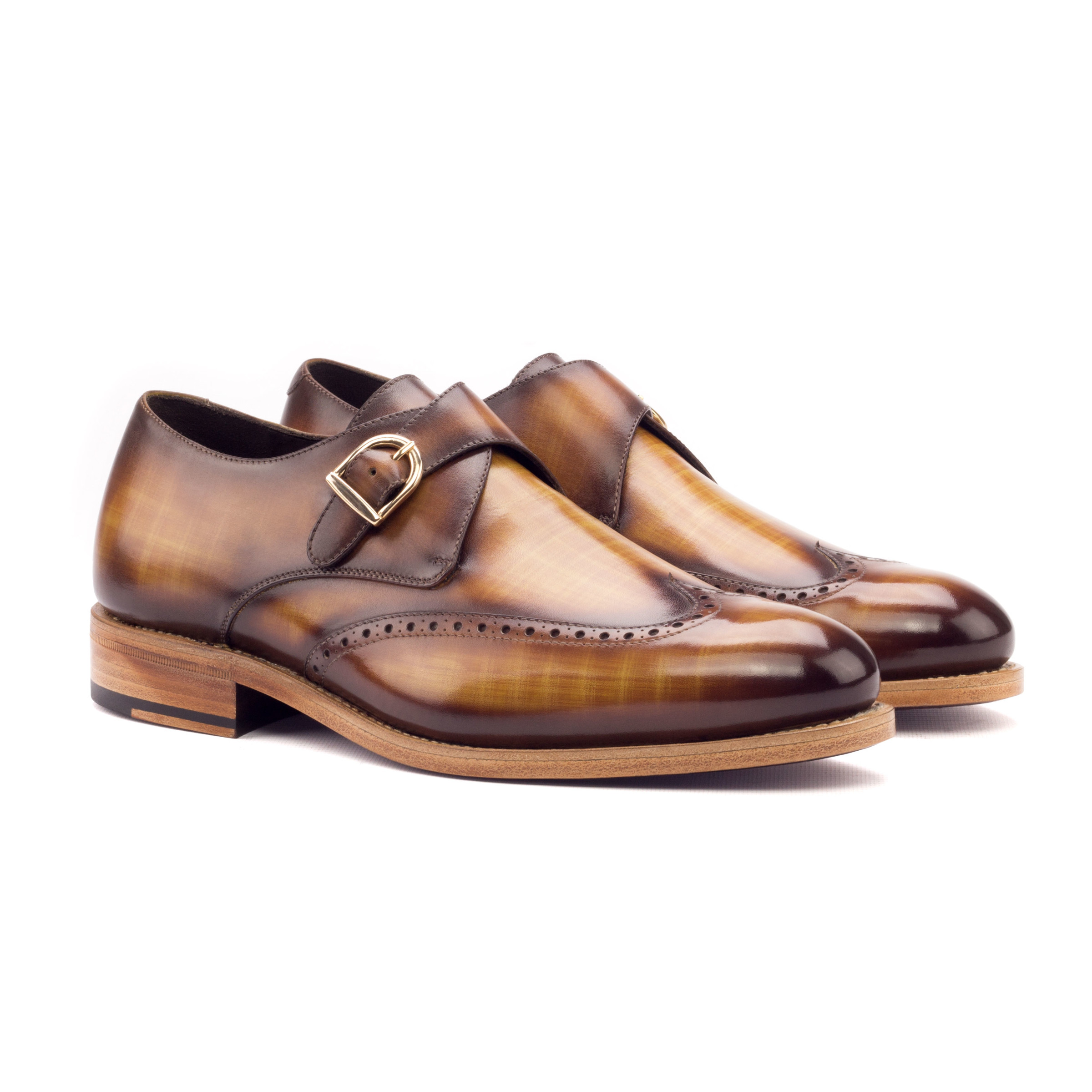 The Abbot: cognac patina brogue. Front facing view of Cognac Patina single strap monk style shoes on white background