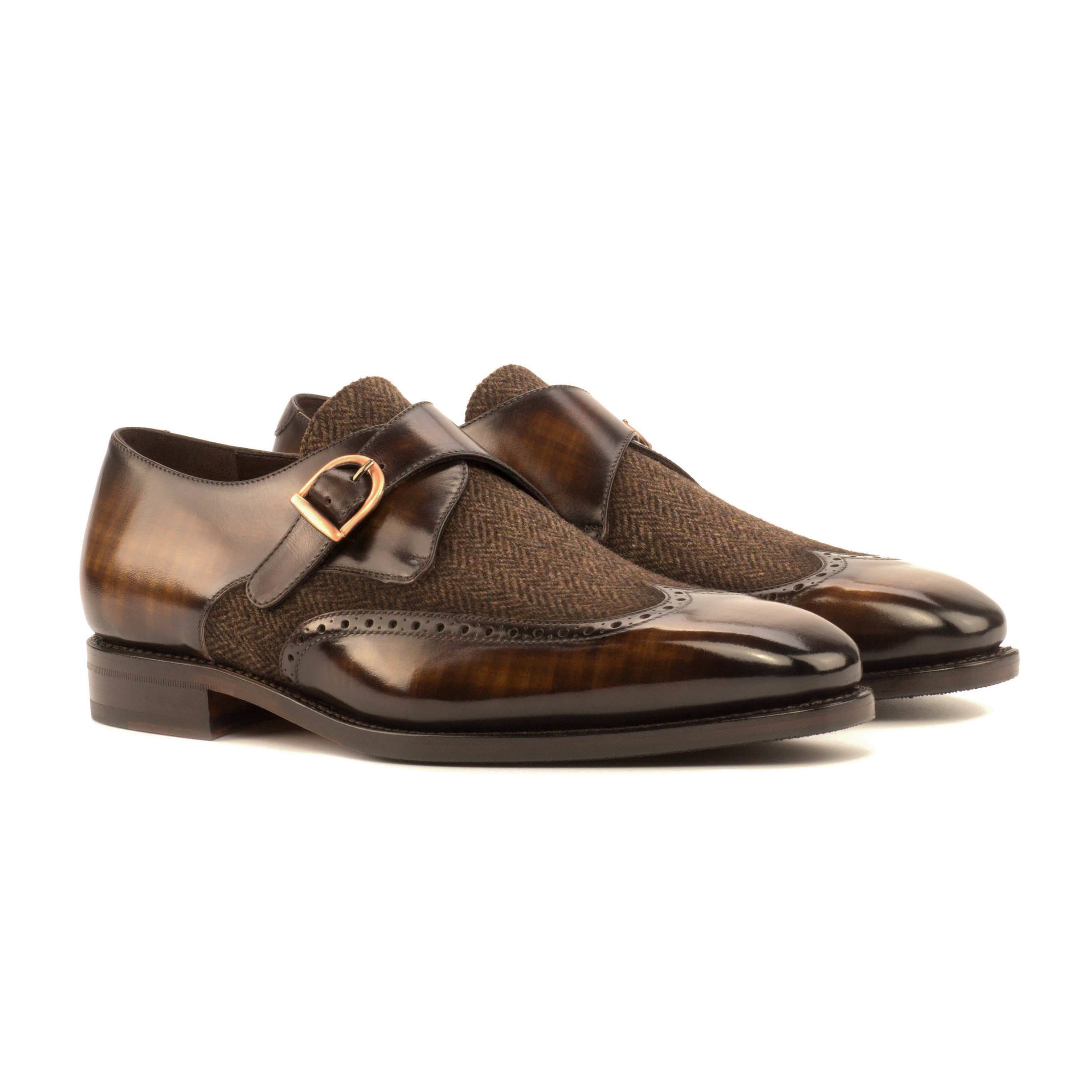 The Abbot: Brown Patina/Herringbone Sartorial. Front facing view of Herringbone sartorial and Brown patina single strap monk style shoes on white background